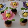 Handmade crochet potted plant features a beautiful blossom