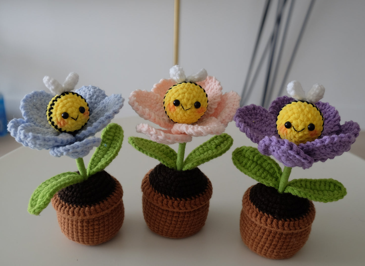 Handmade crochet potted plant features a beautiful blossom