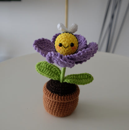 Handmade crochet potted plant features a beautiful blossom