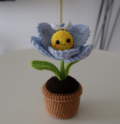 Handmade crochet potted plant features a beautiful blossom