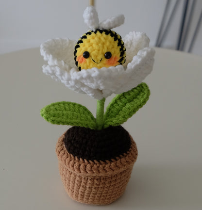 Handmade crochet potted plant features a beautiful blossom