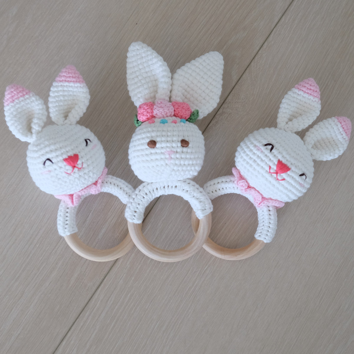 Handmade crochet rattle with a wooden ring base