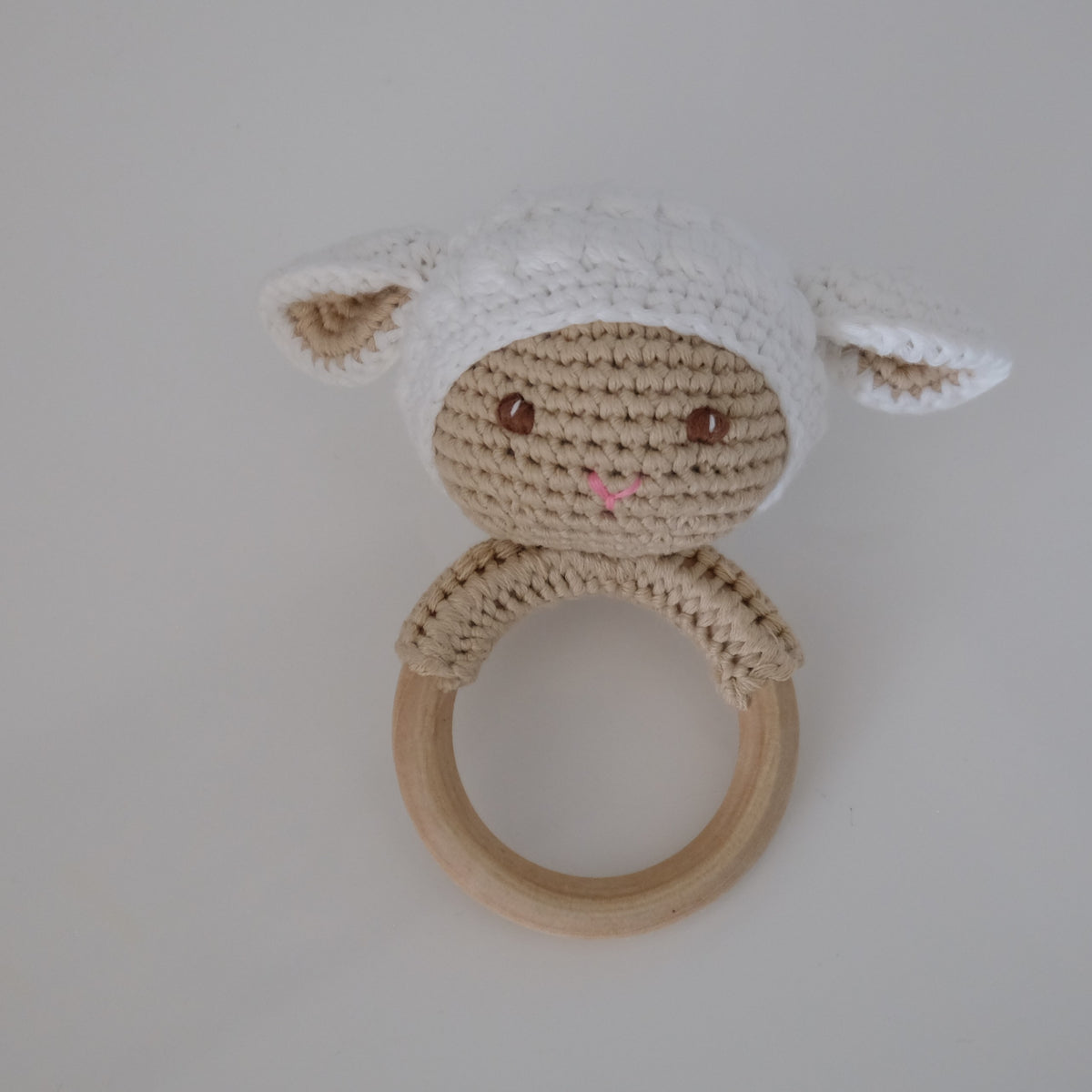 Handmade crochet rattle with a wooden ring base