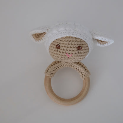 Handmade crochet rattle with a wooden ring base