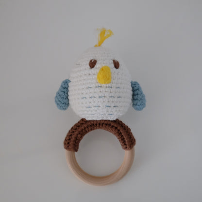 Handmade crochet rattle with a wooden ring base