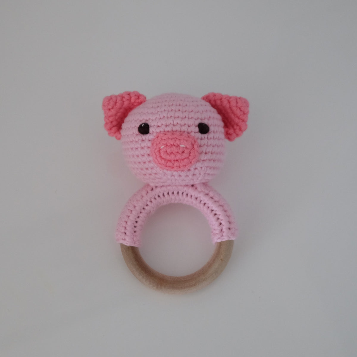 Handmade crochet rattle with a wooden ring base