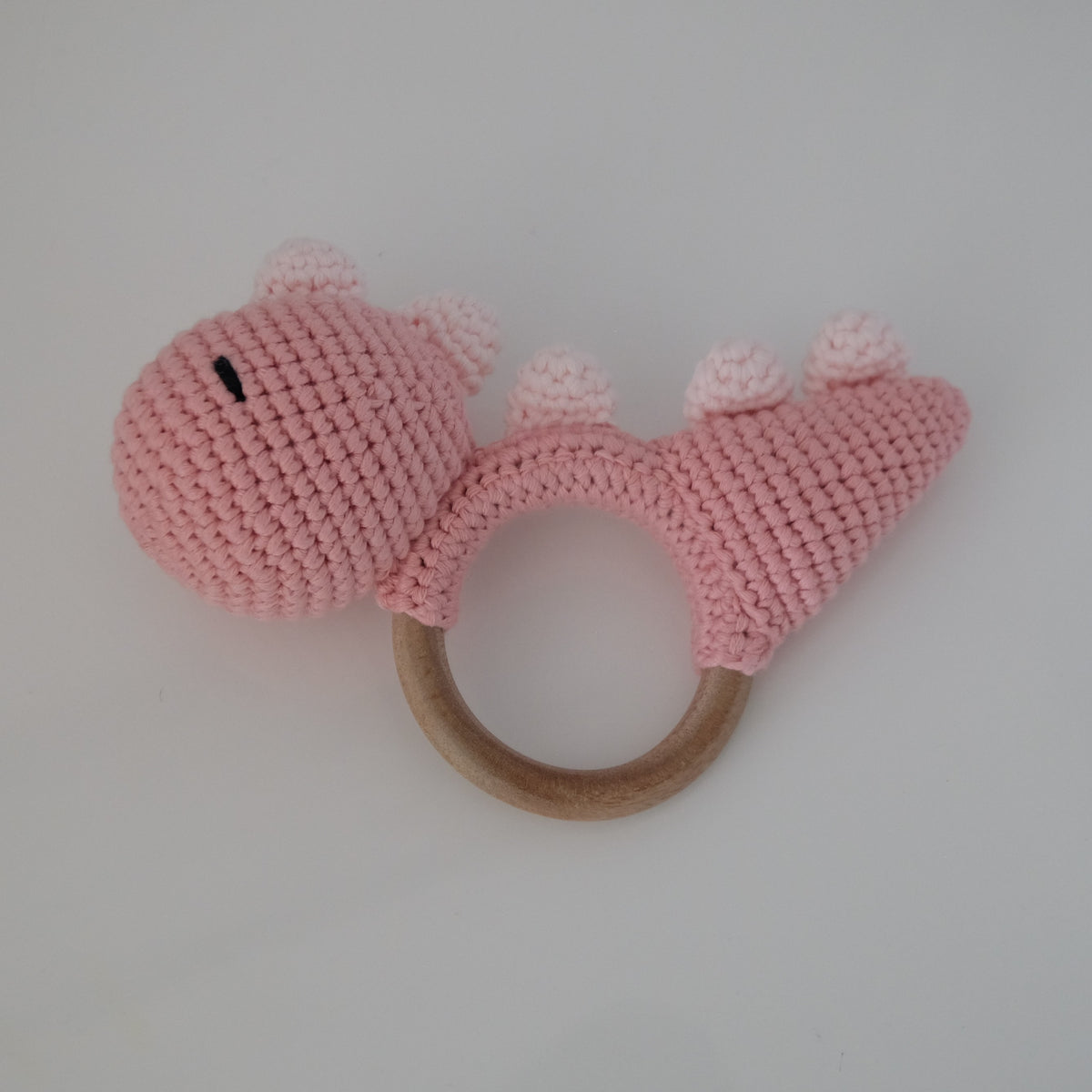 Handmade crochet rattle with a wooden ring base