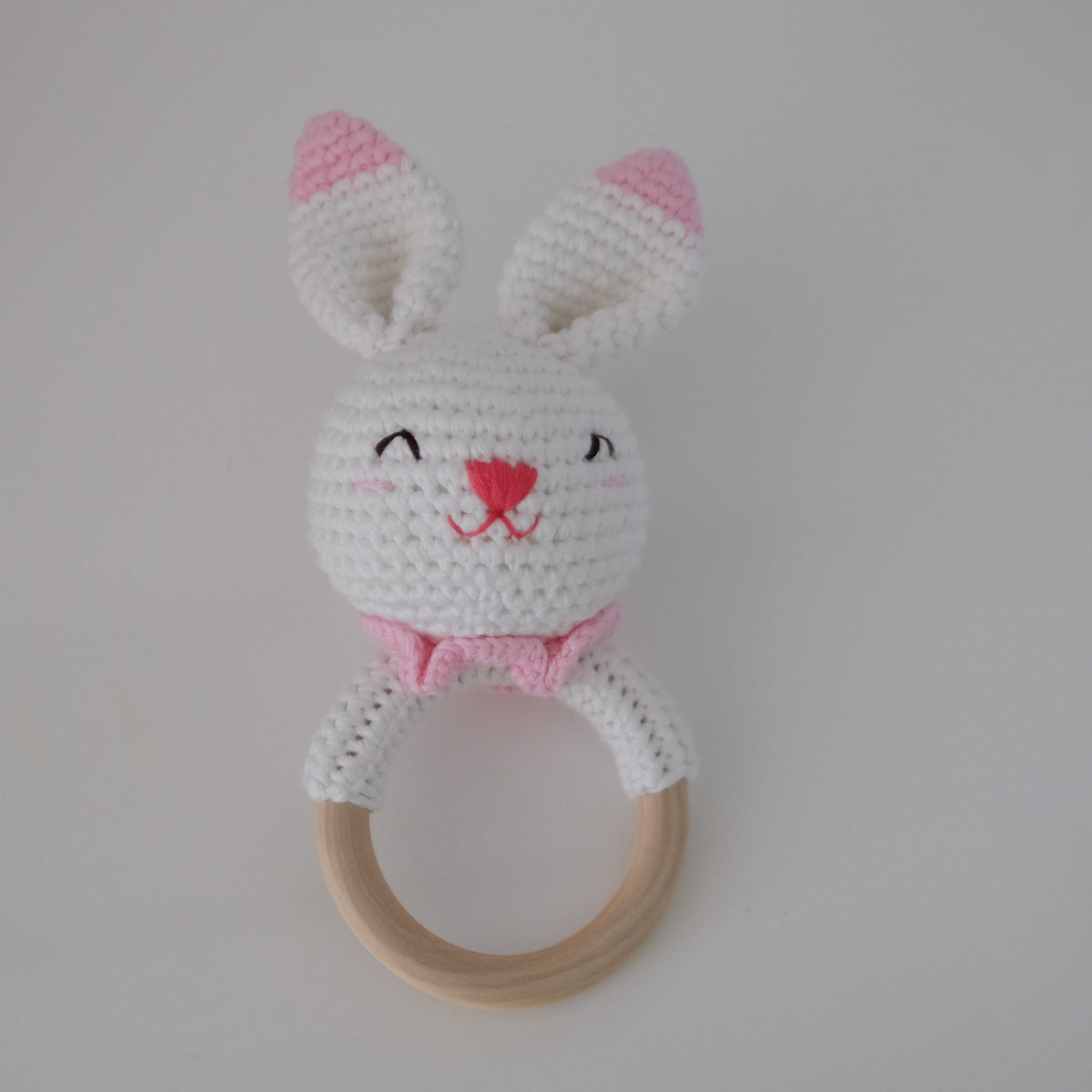 Handmade crochet rattle with a wooden ring base