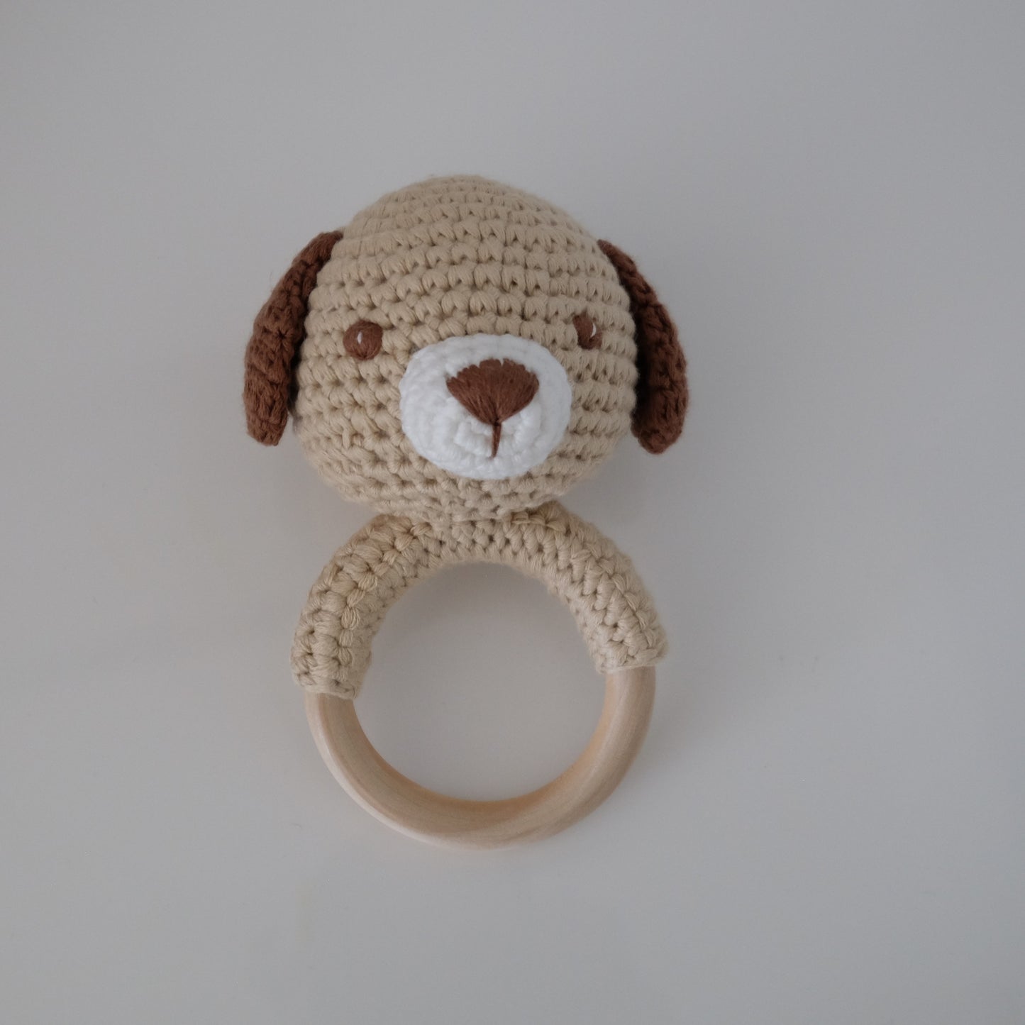 Handmade crochet rattle with a wooden ring base