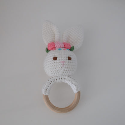 Handmade crochet rattle with a wooden ring base